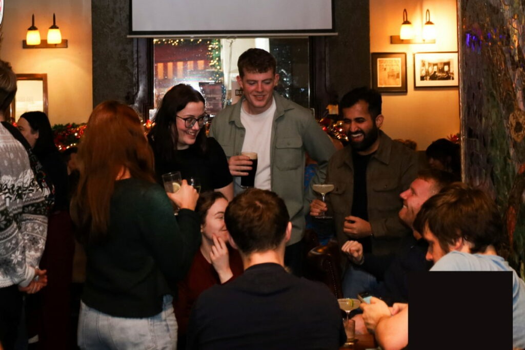 Friends chatting with drinks in cosy pub